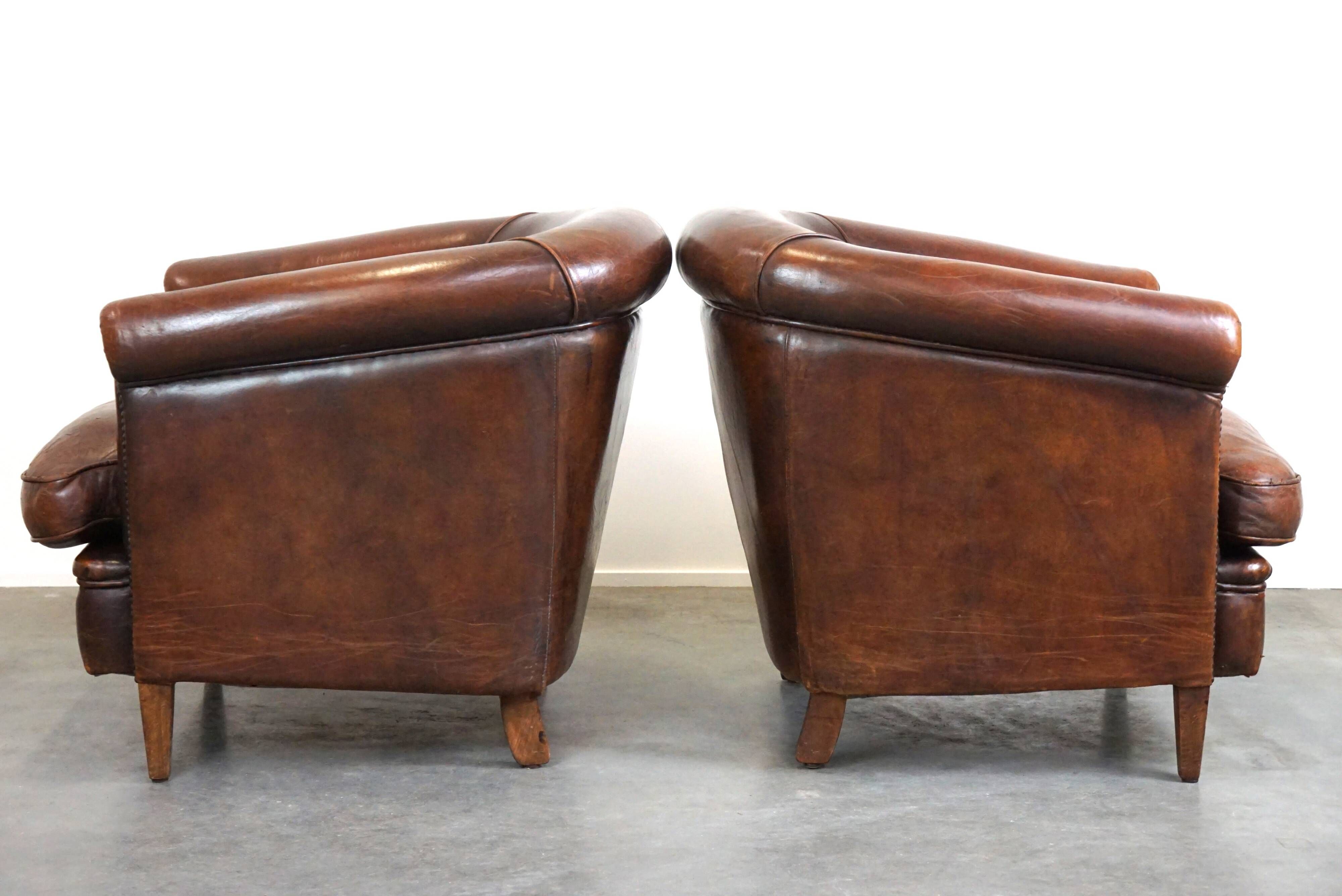 Set of two rugged sheep let of two rugged sheep leather club armchairs with a nice distressed look