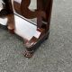 Mahogany console with grey marble top and lion paw feet.