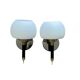 Pair of wall sconces with brass torch and white glass globe.