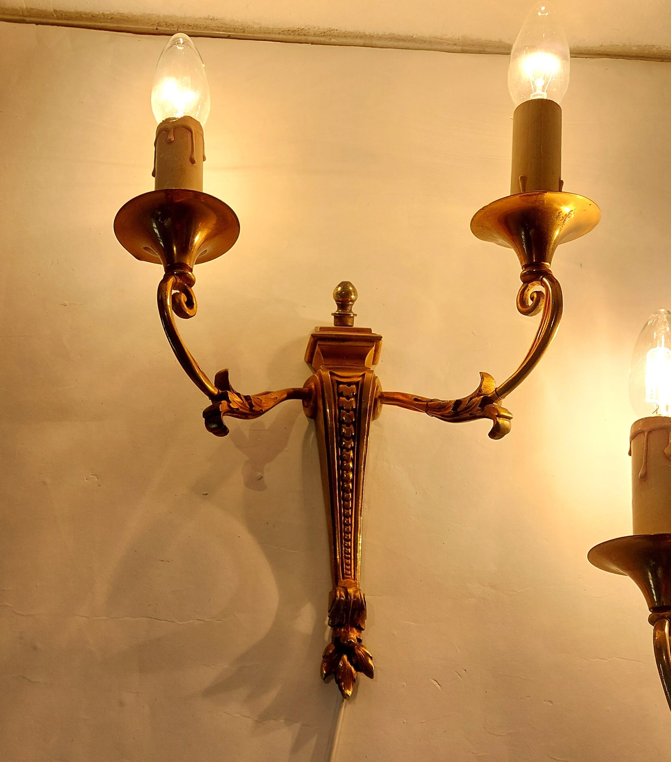 Pair of neoclassical sconces in bronze and gilded brass 1950.