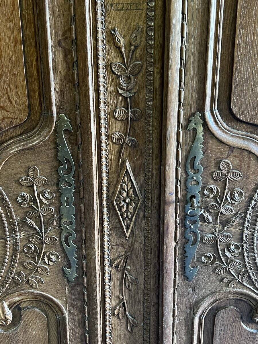 19th-century Norman wedding armoire, with bouquets of flowers and doves.