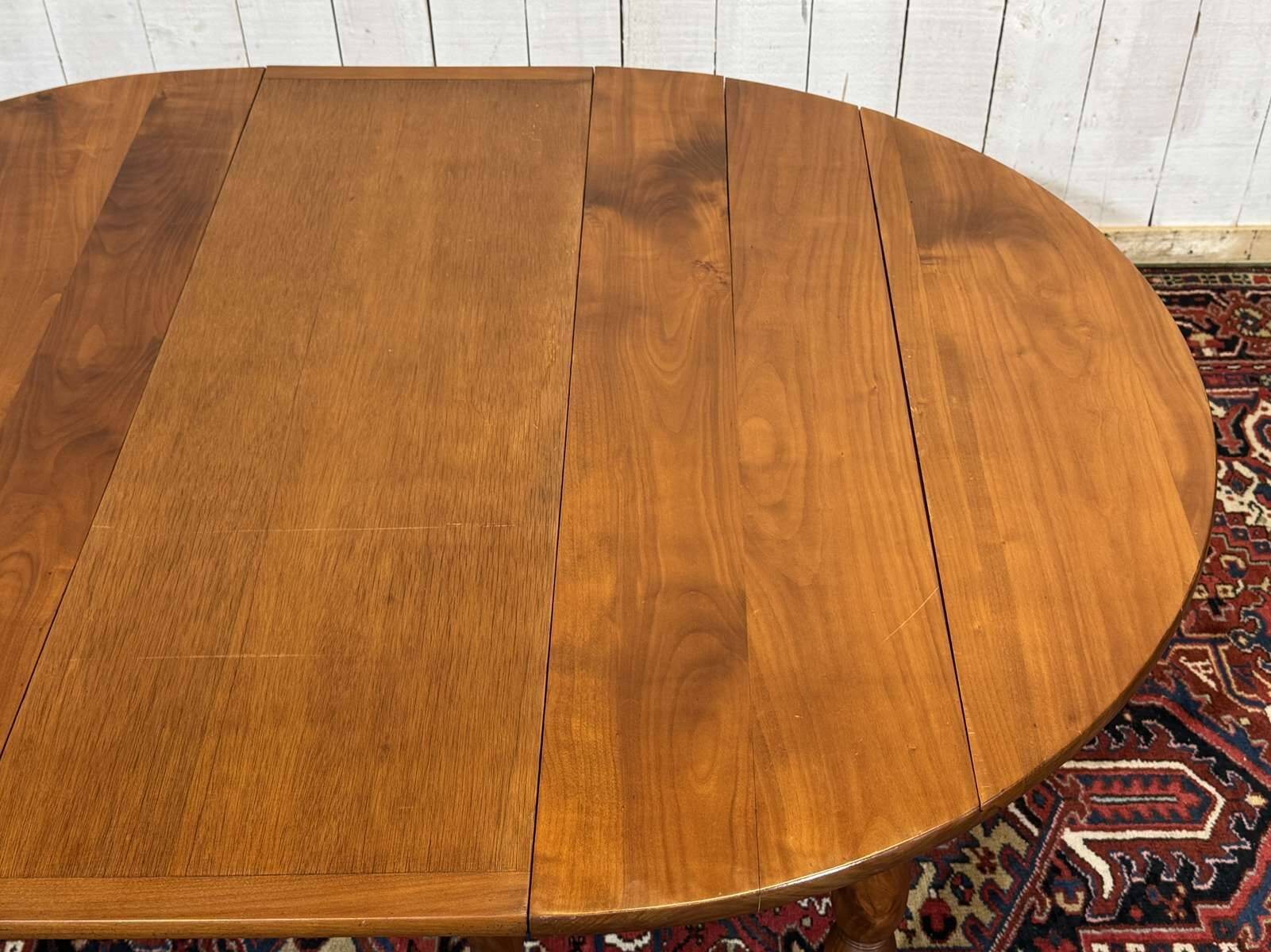 Round cherry wood table, 6 feet, Louis Philippe style with 2 extensions.