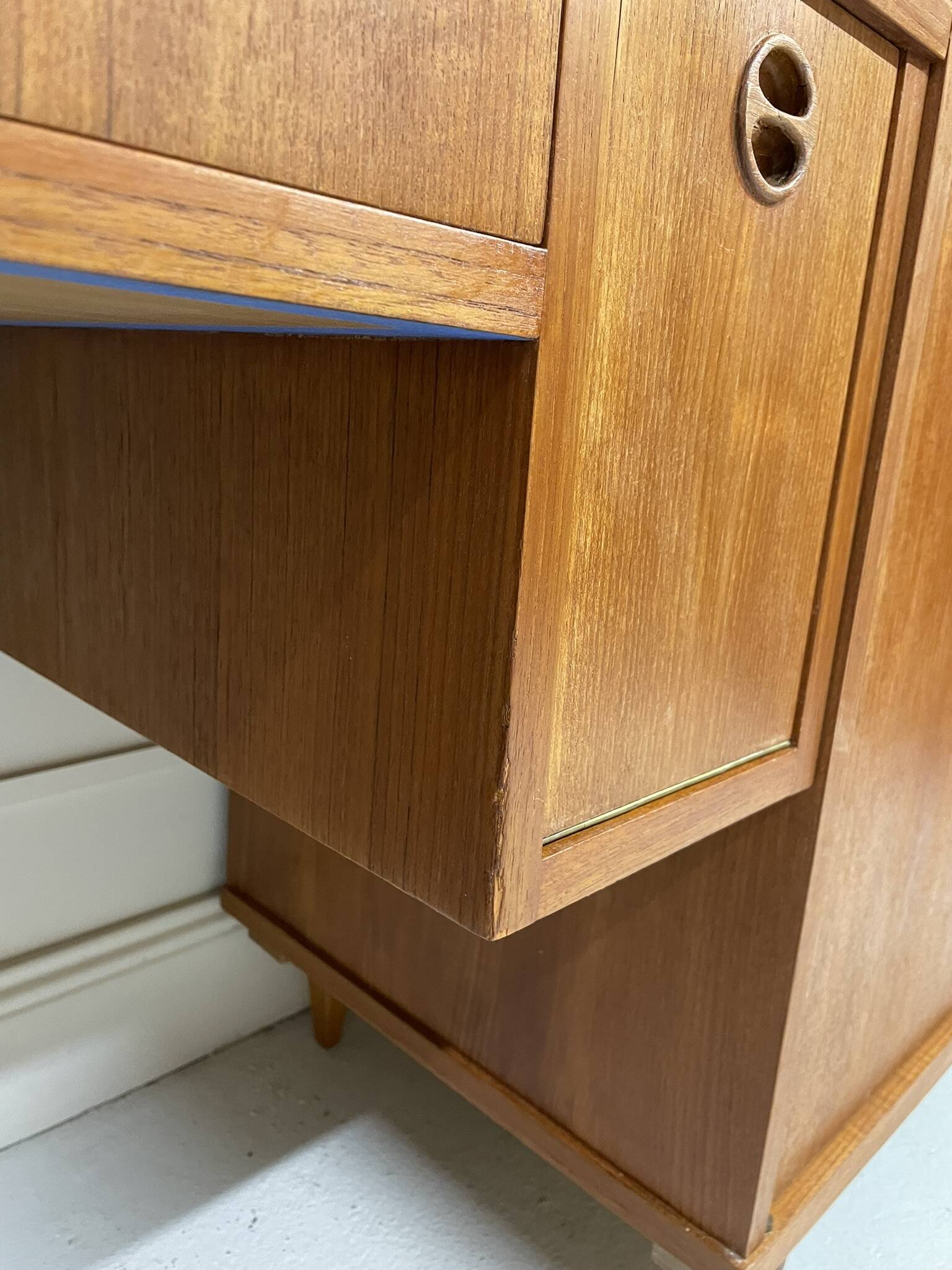 A piece of furniture combining a desk, wardrobe, and shelves.