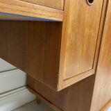 A piece of furniture combining a desk, wardrobe, and shelves.