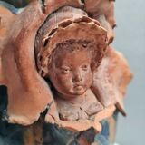Terracotta vase with a child's head