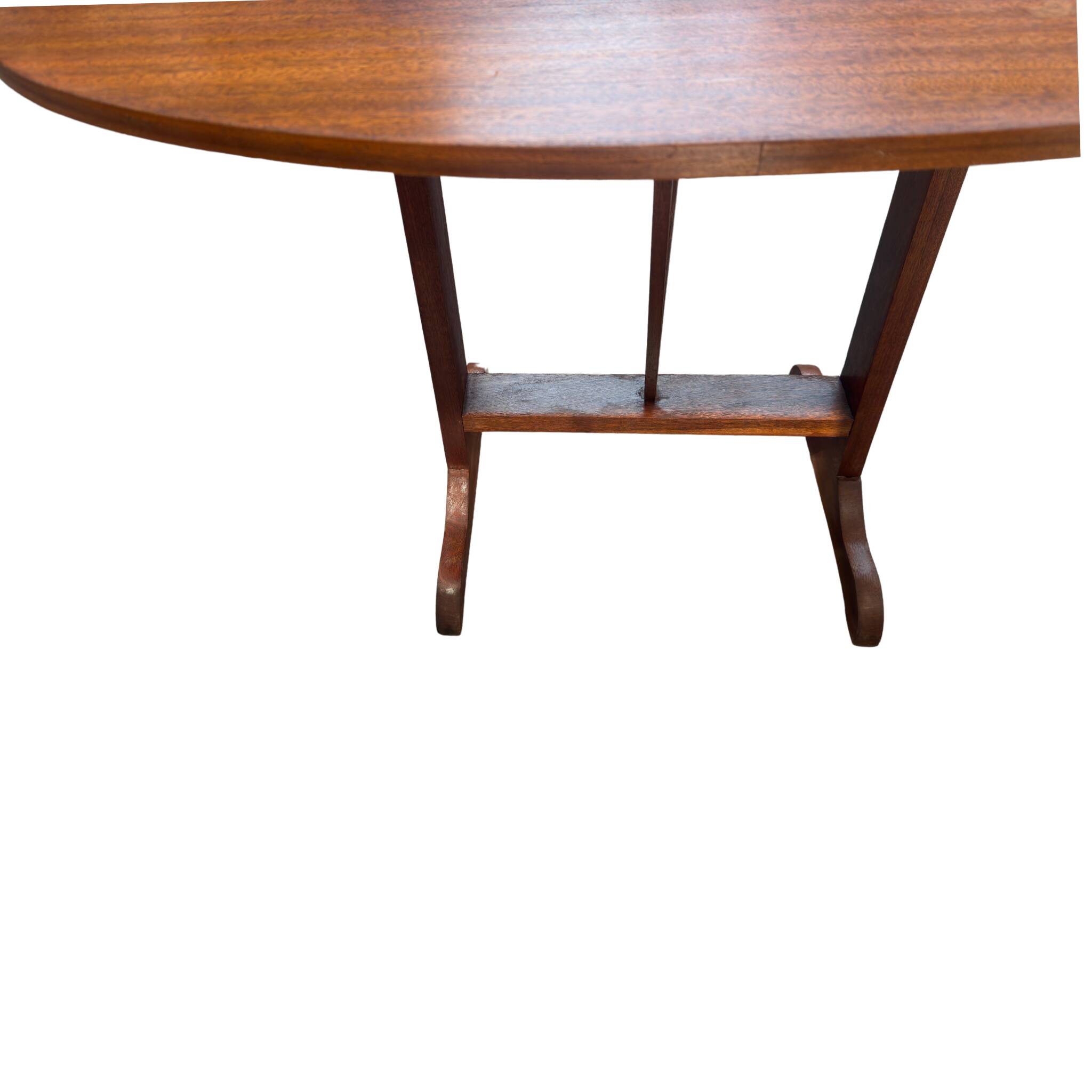 Oval folding table – mahogany veneer – V-shaped base – France, circa 1970