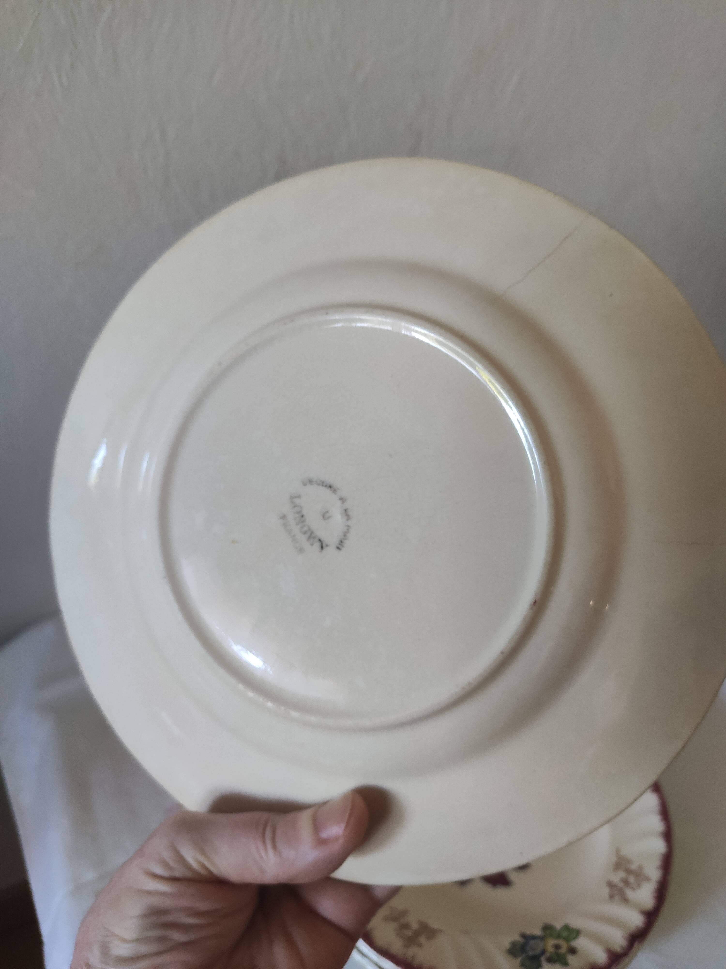 Set of 5 flat plates, signed Longwy.