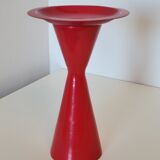 Vintage design candlestick in red metal in the shape of an hourglass
