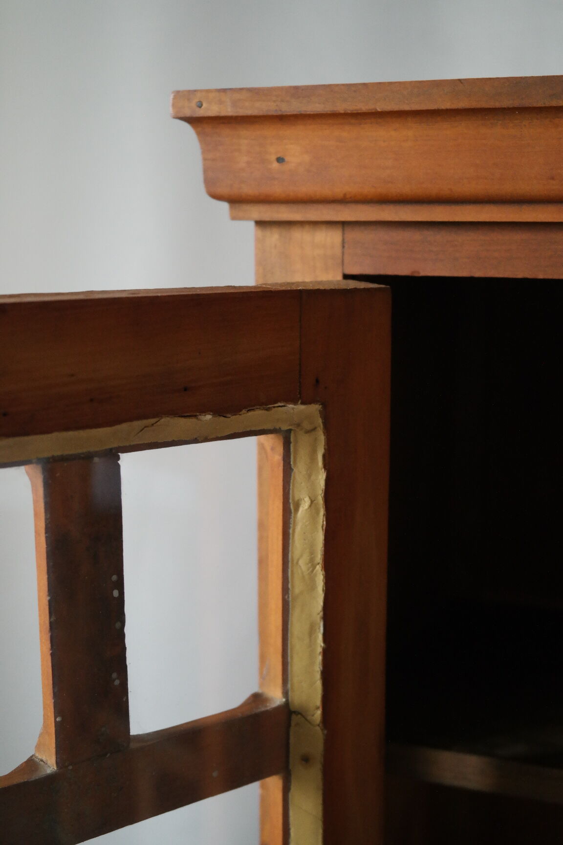 Antique walnut display cabinet from the 20th century.