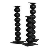three designer candle holders in matte black metal