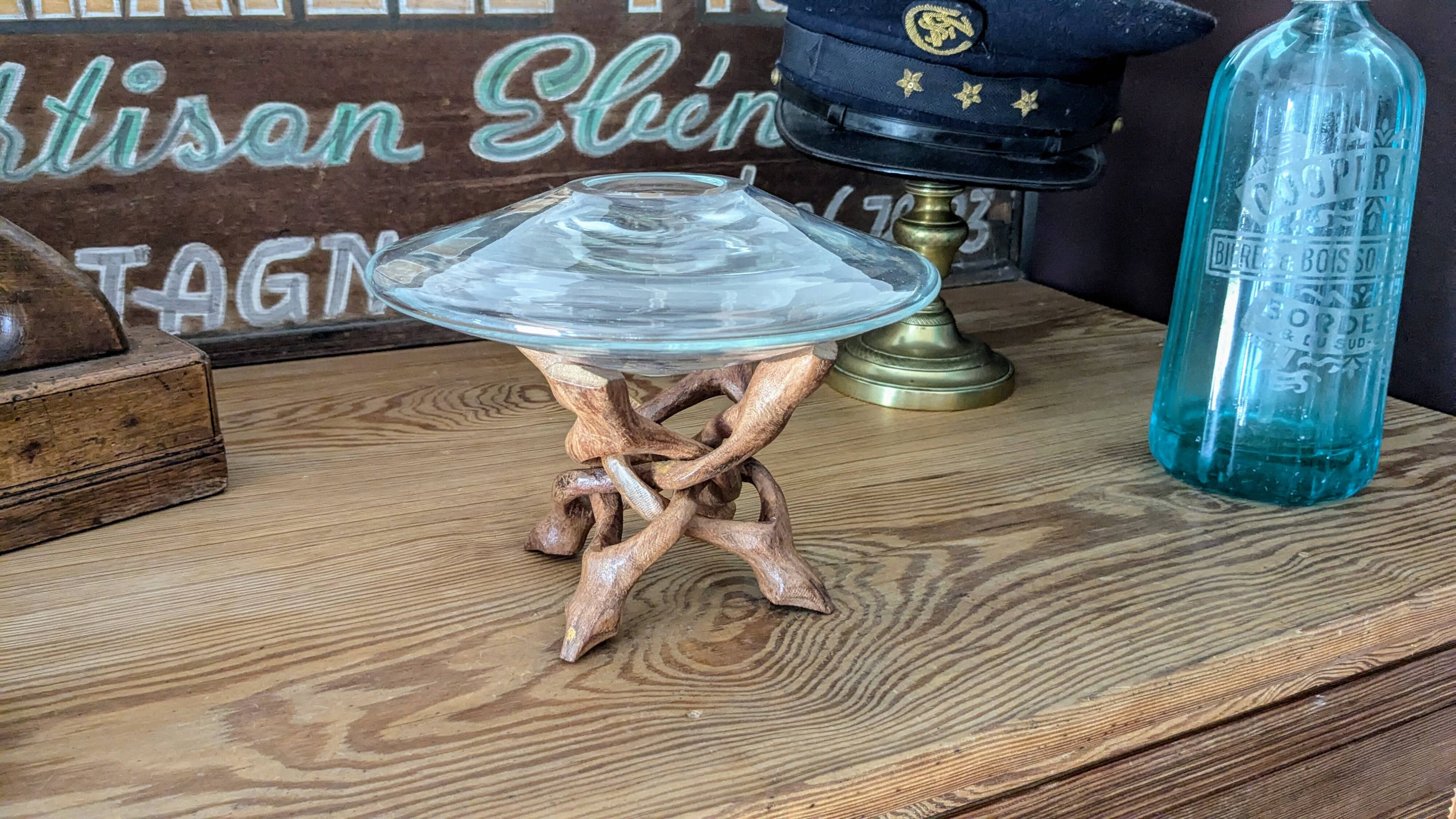 Glass cup molded on carved exotic wood