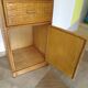 Storage column, wooden bookshelf and woven rattan.