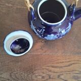Small blue teapot and its wicker handle