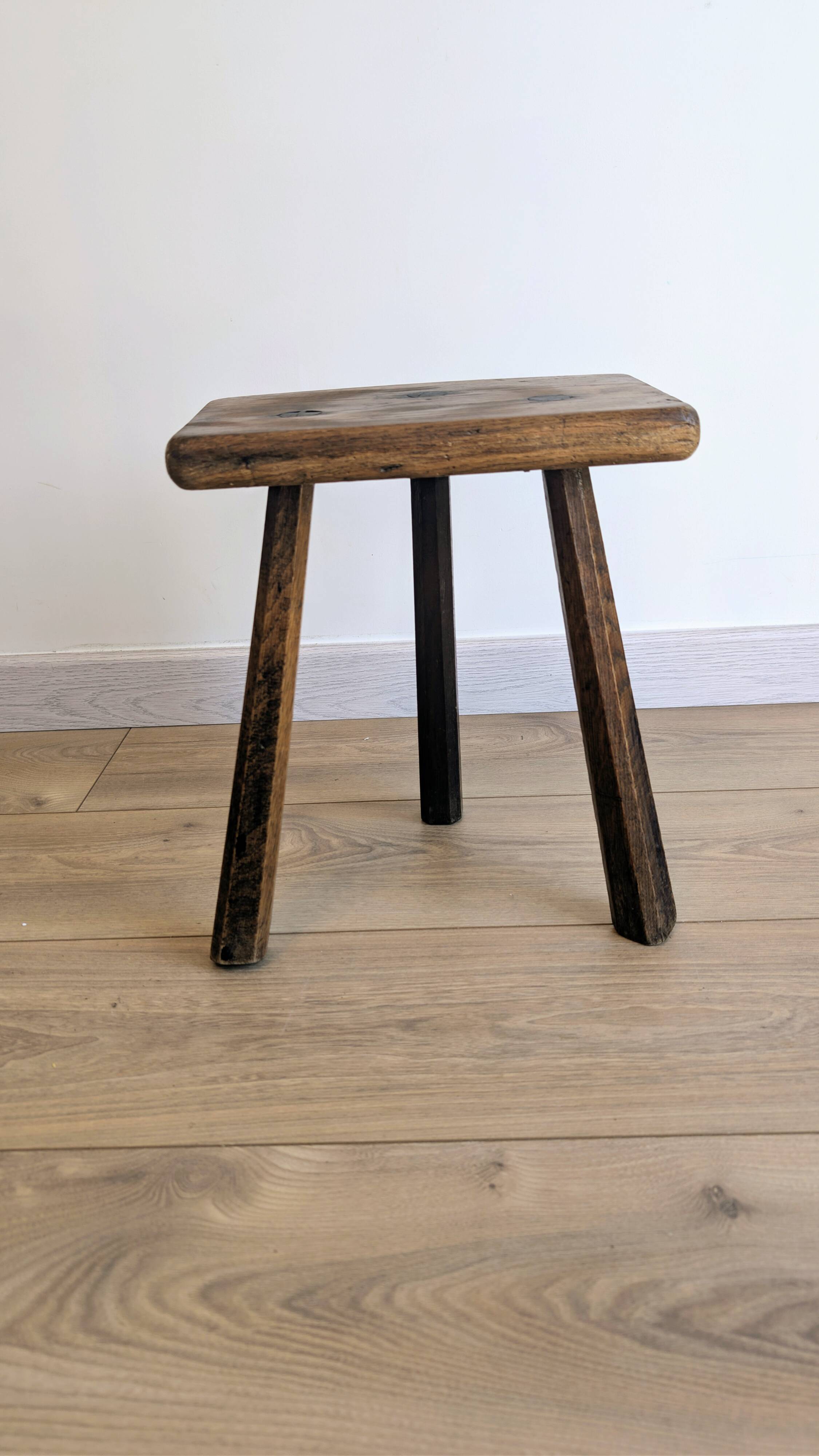 Antique tripod stool in patinated solid wood