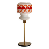 Table lamp with a vintage globe with orange patterns from the 70s and a golden base