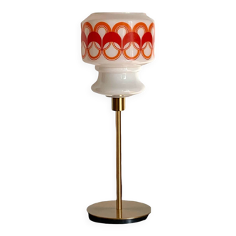 Table lamp with a vintage globe with orange patterns from the 70s and a golden base