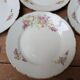7 dessert plates in porcelain with a violet lilac design and a gold rim.