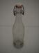 Bottle with mechanical closure in white glass and porcelain stopper.