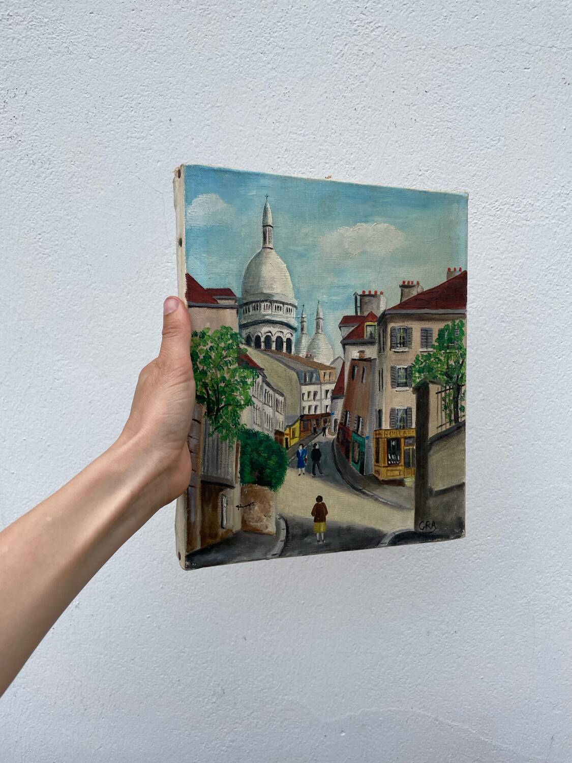 Old oil painting depicting a street in Montmartre