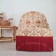 Beige toad armchair with floral patterns and red fringes