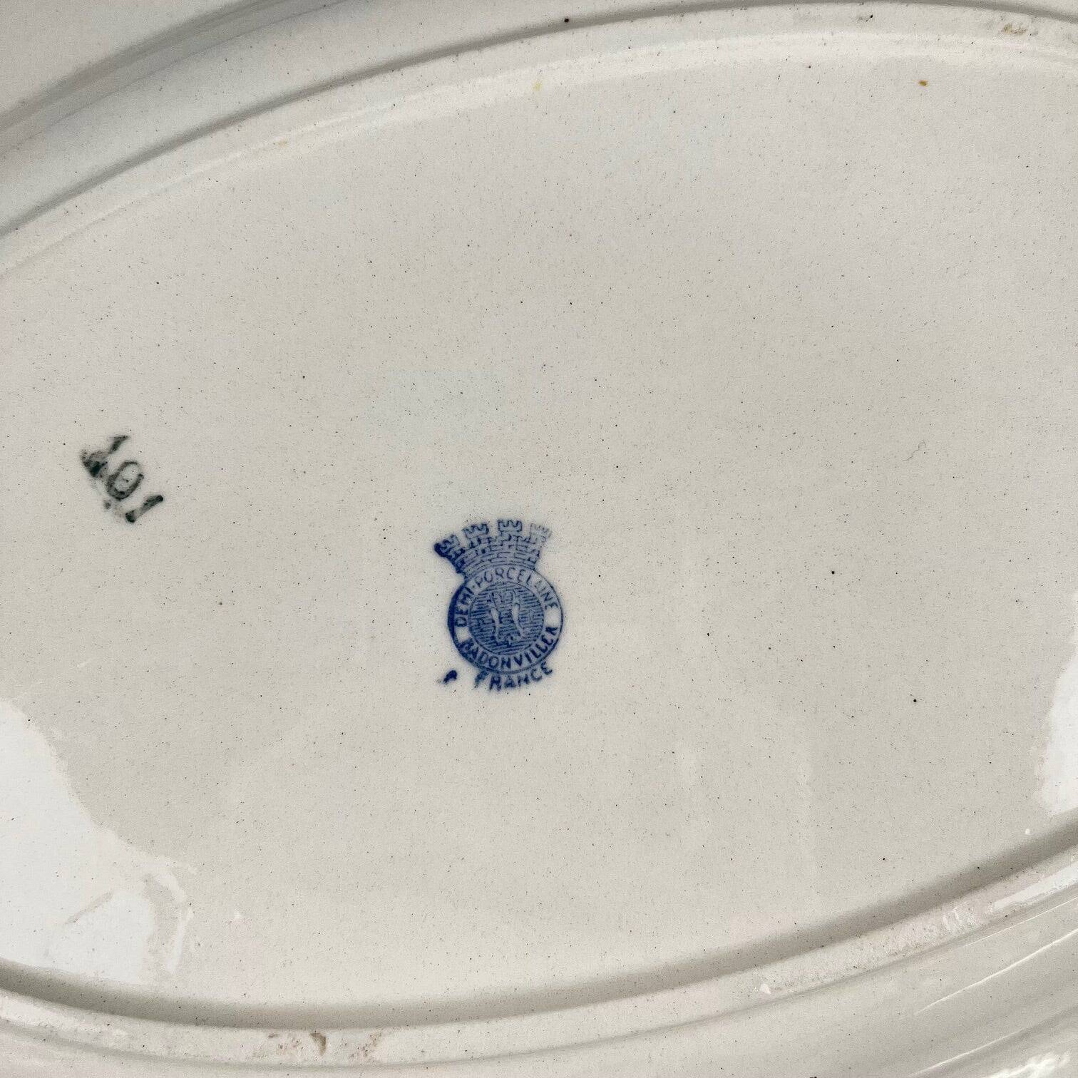 Oval half-porcelain plate from Badonviller, blue flower pattern, early 20th century.