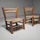 Pair of rustic French low chairs made of elm wood and straw, 1960s.