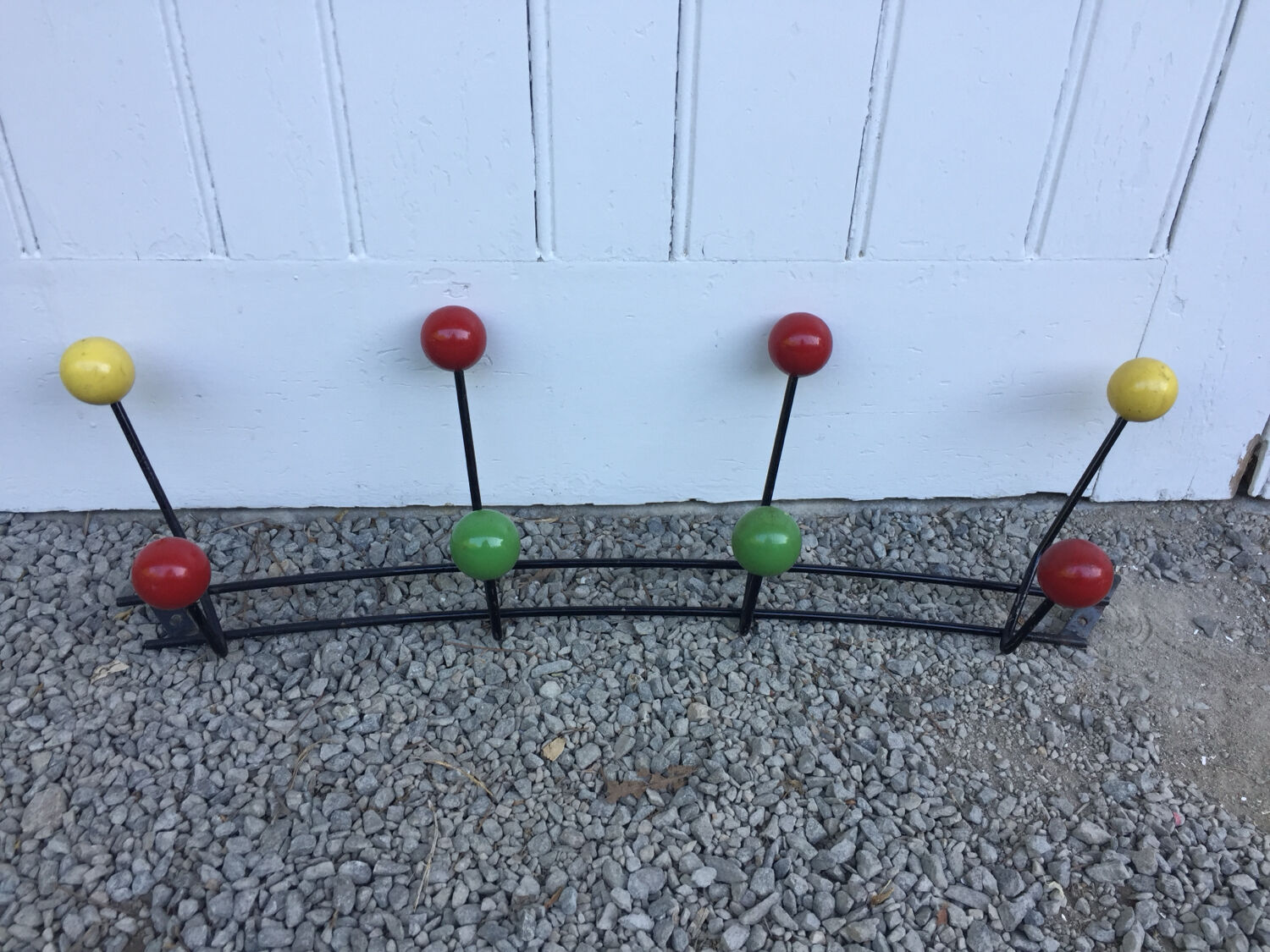 Roger Feraud wall-mounted wooden coat rack with colored balls, 1950