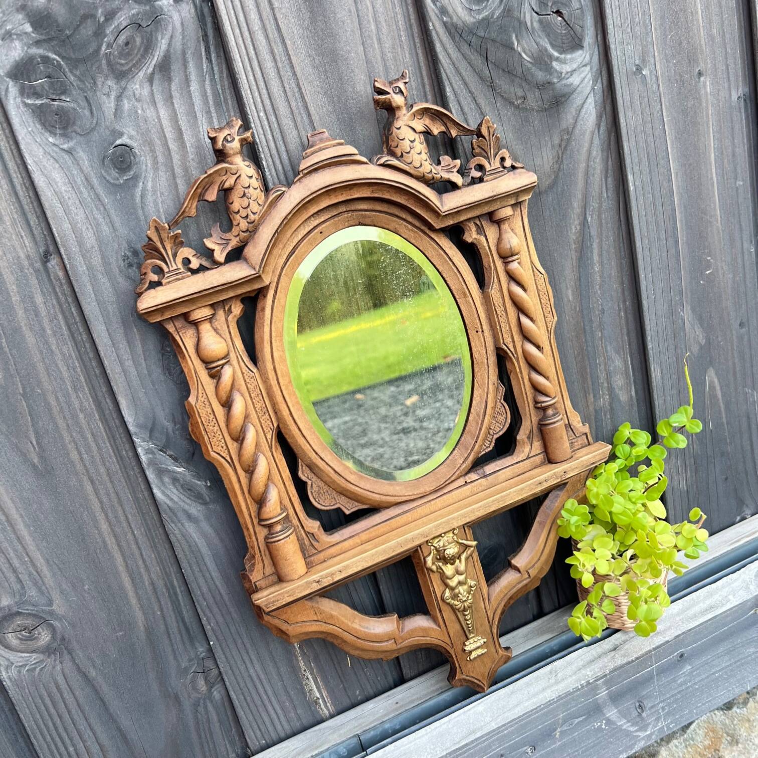 Antique “dragons” mirror in carved wood