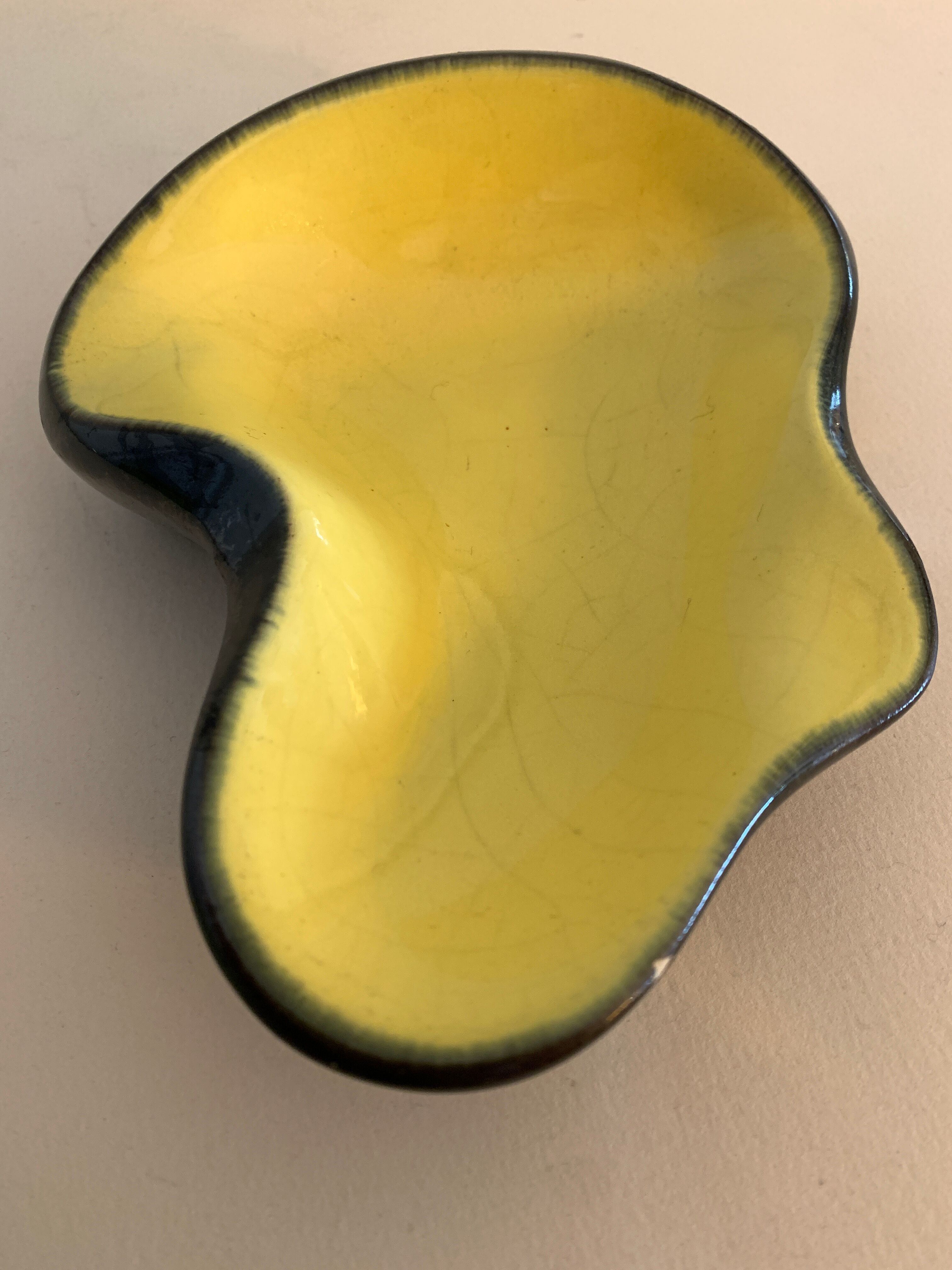 Yellow and black ceramic ashtray