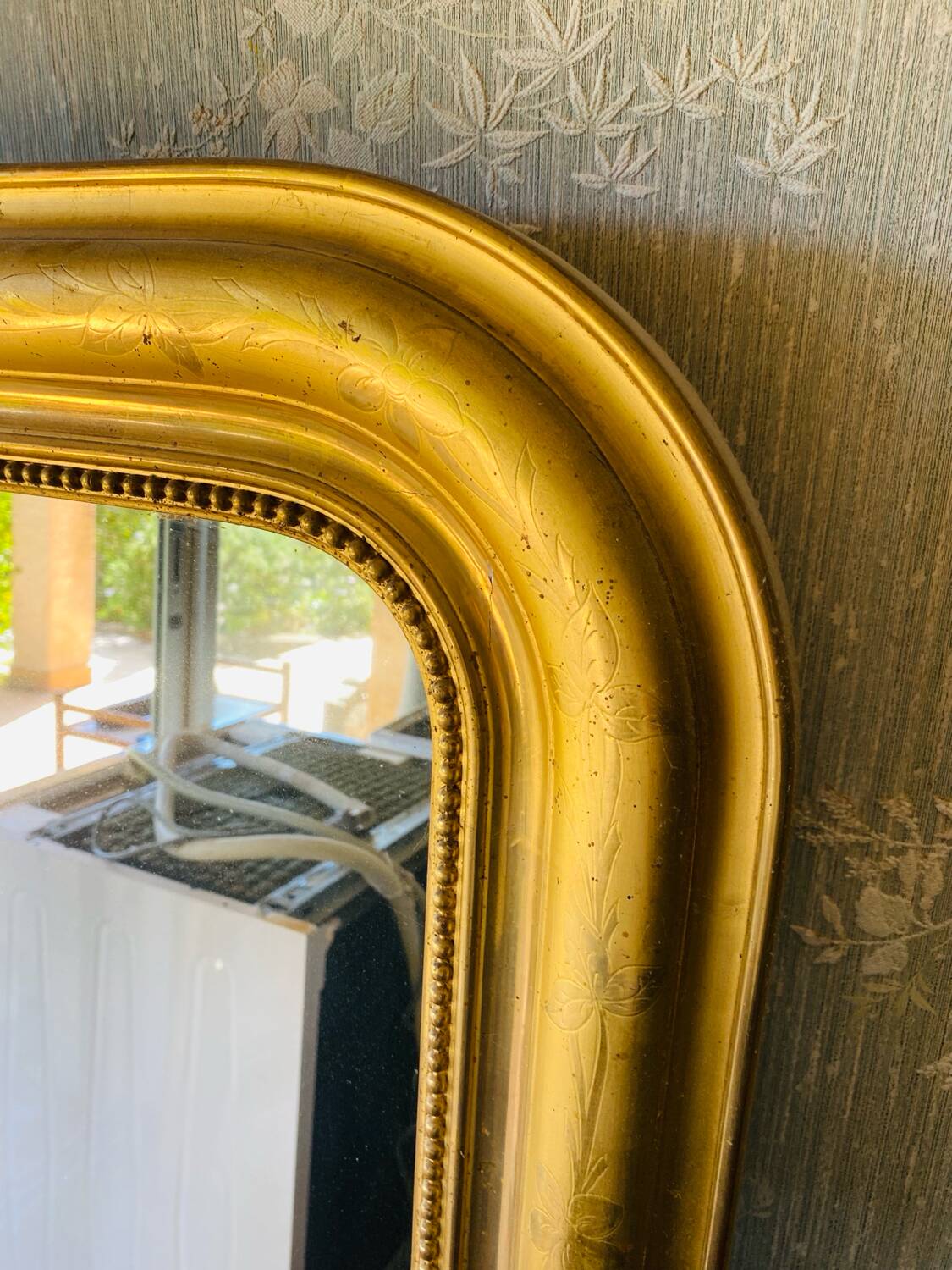 Large antique mirror with gold leaf in the Louis XV style.