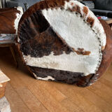 Pair of club chairs covered in cowhide