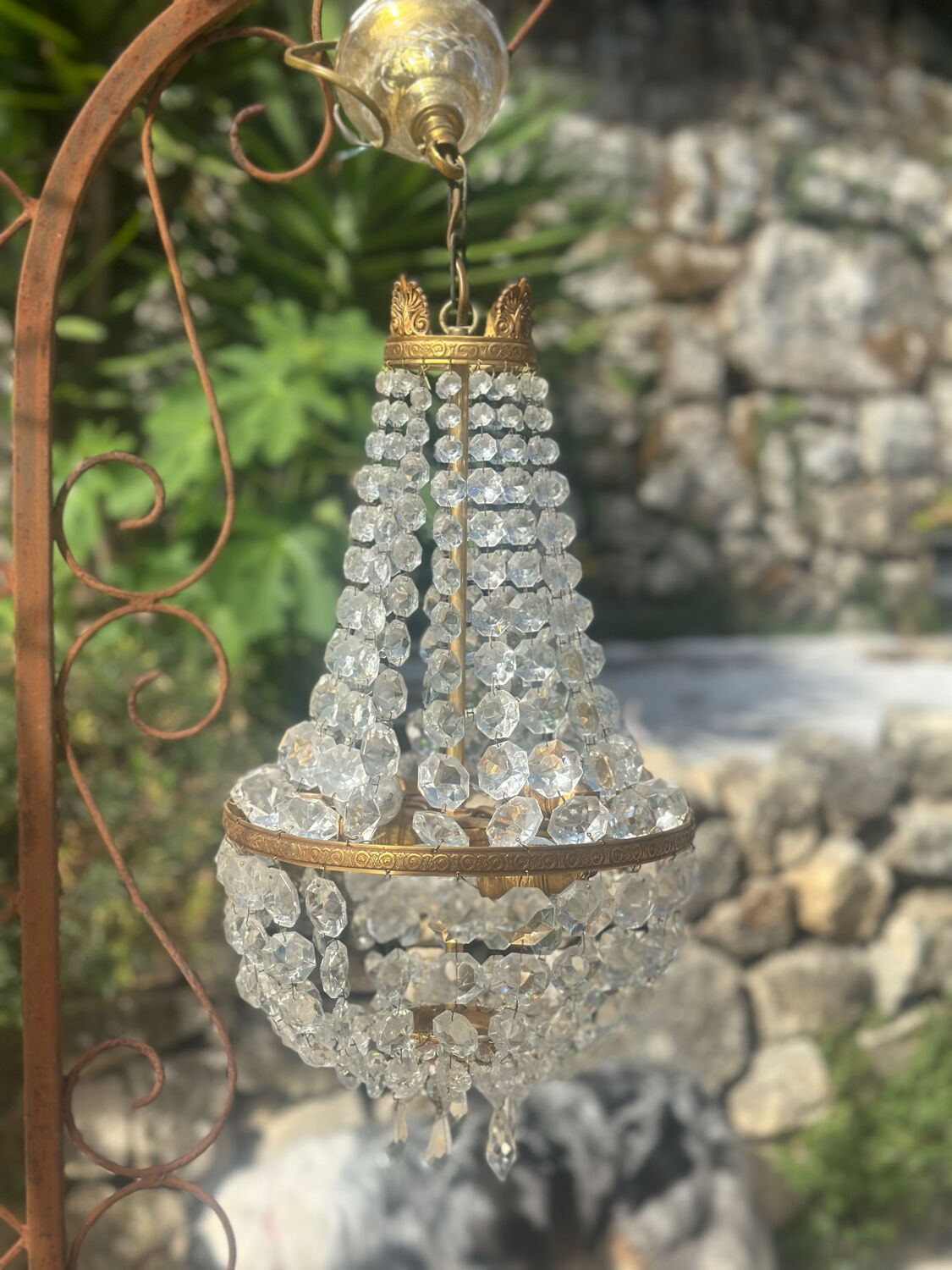 Basket chandelier with crystal and gilded brass pendants, circa 1930.