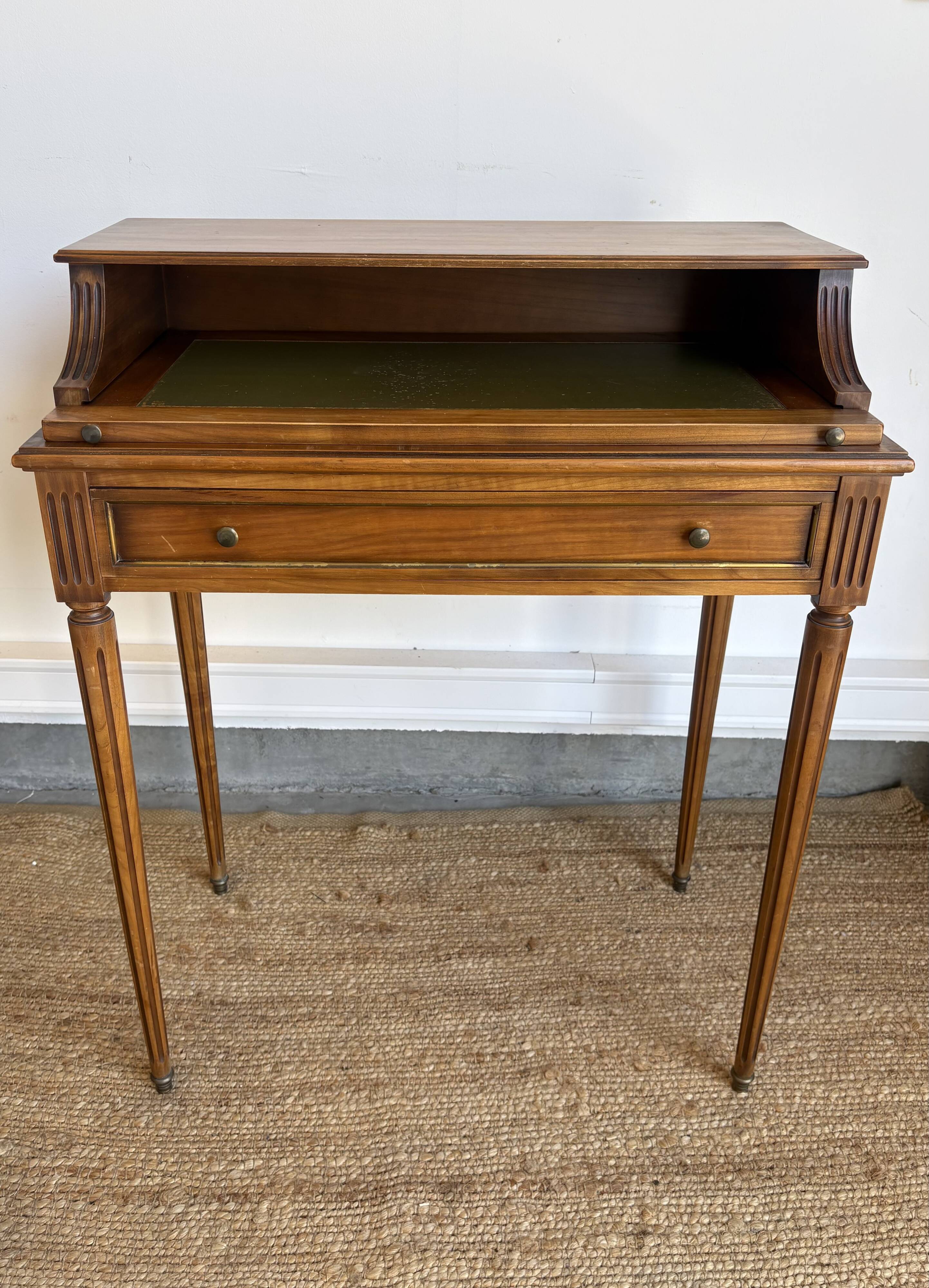 Louis XVI style mahogany telephone table with a green leather top.