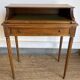 Louis XVI style mahogany telephone table with a green leather top.