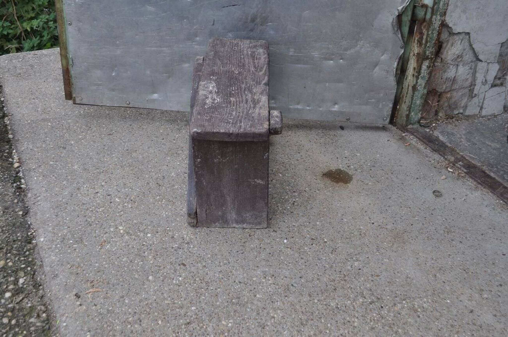 Low stool in vintage brown painted pine from the 1940s, with a rectangular seat.