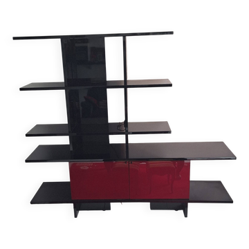 Black and burgundy lacquered shelving unit.
