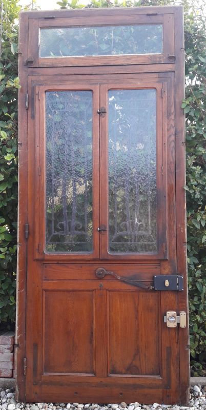 Oak entrance door and its frame and transom, wrought iron gates