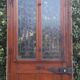 Oak entrance door and its frame and transom, wrought iron gates