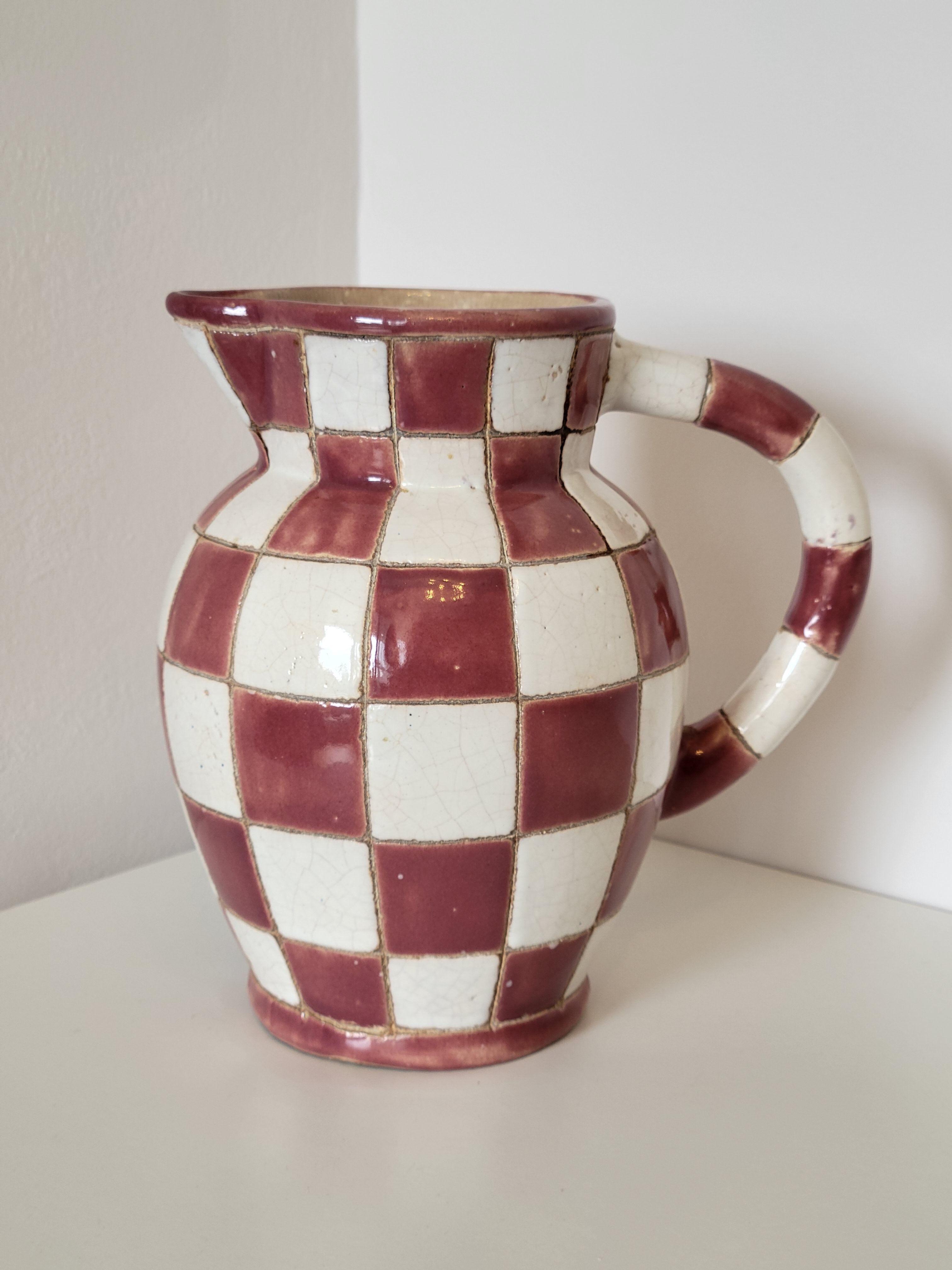 Old ceramic pitcher pattern checkerboard tiles