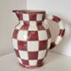 Old ceramic pitcher pattern checkerboard tiles