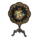 Blackened wooden side table decorated with a painted bouquet of flowers.