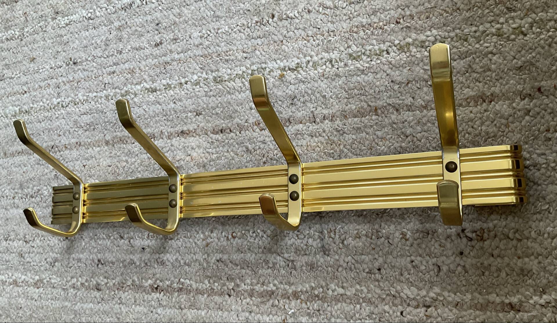 Golden wall-mounted coat rack from the 70s.