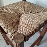 Antique campaign stool in solid wood with a straw seat.