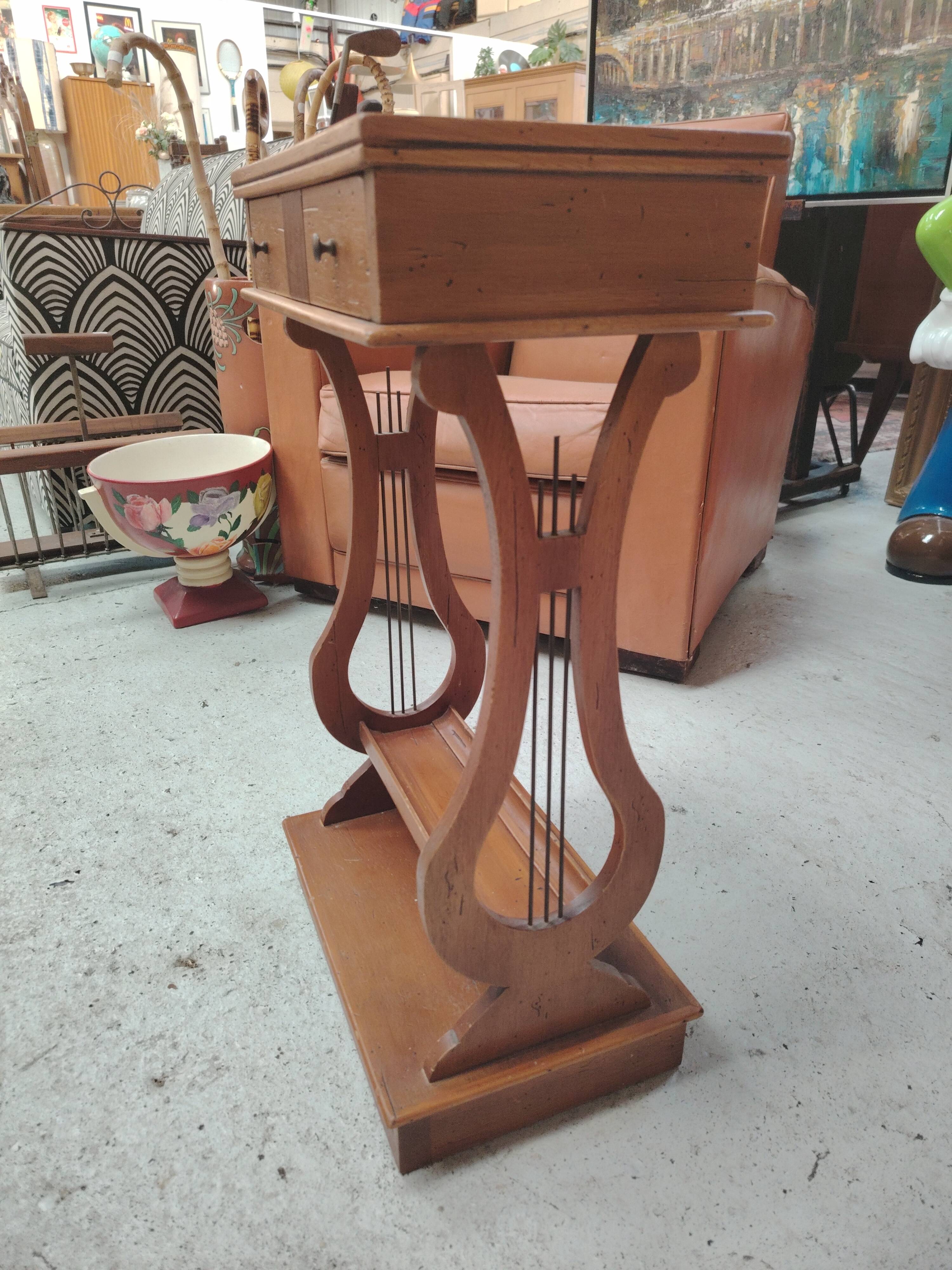 Vintage end table with lyre legs and two drawers.