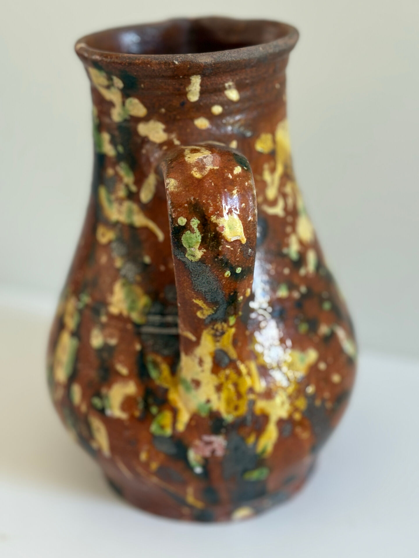 Studio ceramic pitcher with sprayed glazes – circa 1960-70