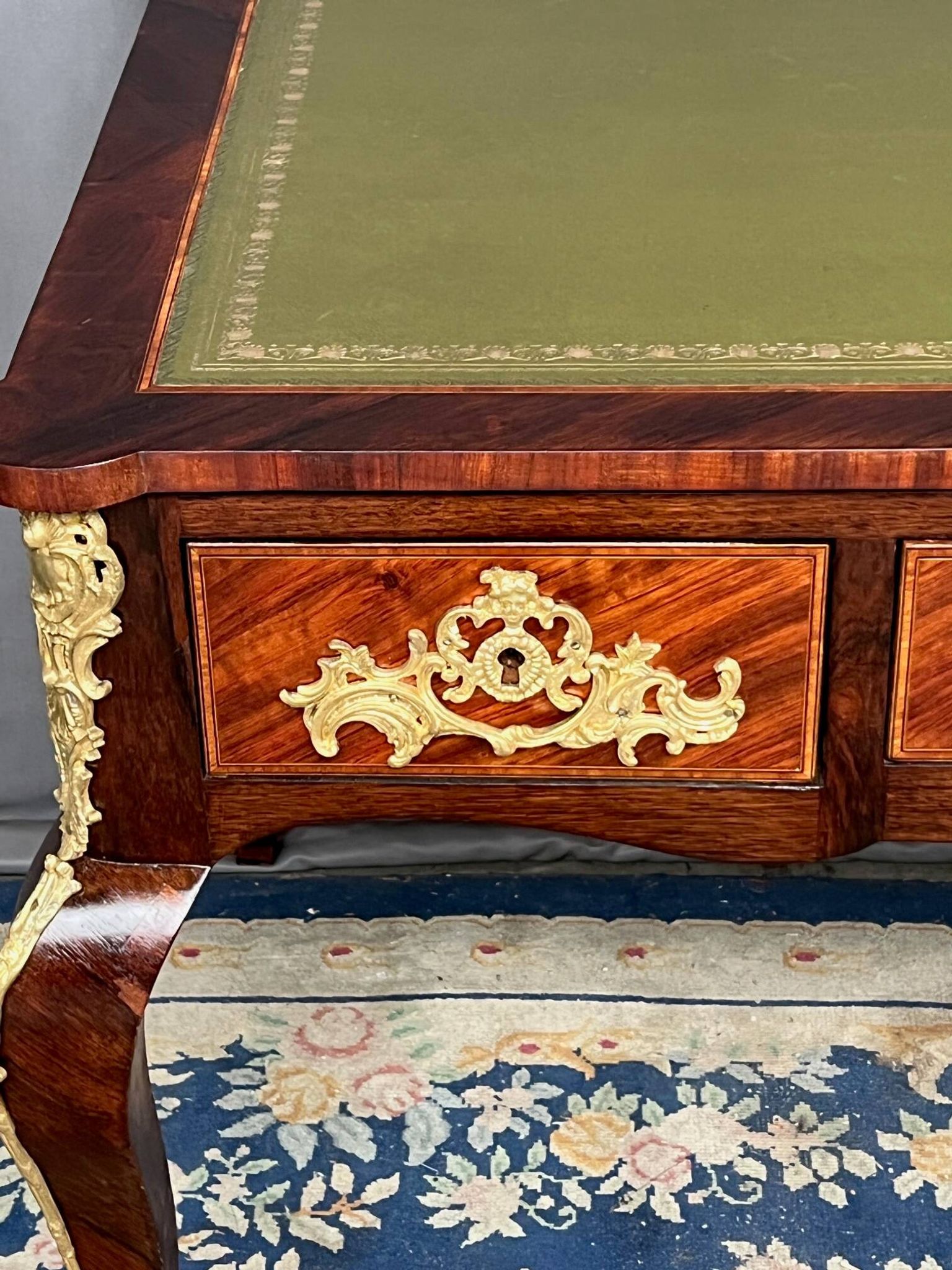 Louis XV style desk. Rosewood veneer, gilt bronze decoration, leather.