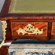 Louis XV style desk. Rosewood veneer, gilt bronze decoration, leather.