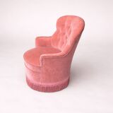 Vintage pink velvet tufted armchair with fringes.