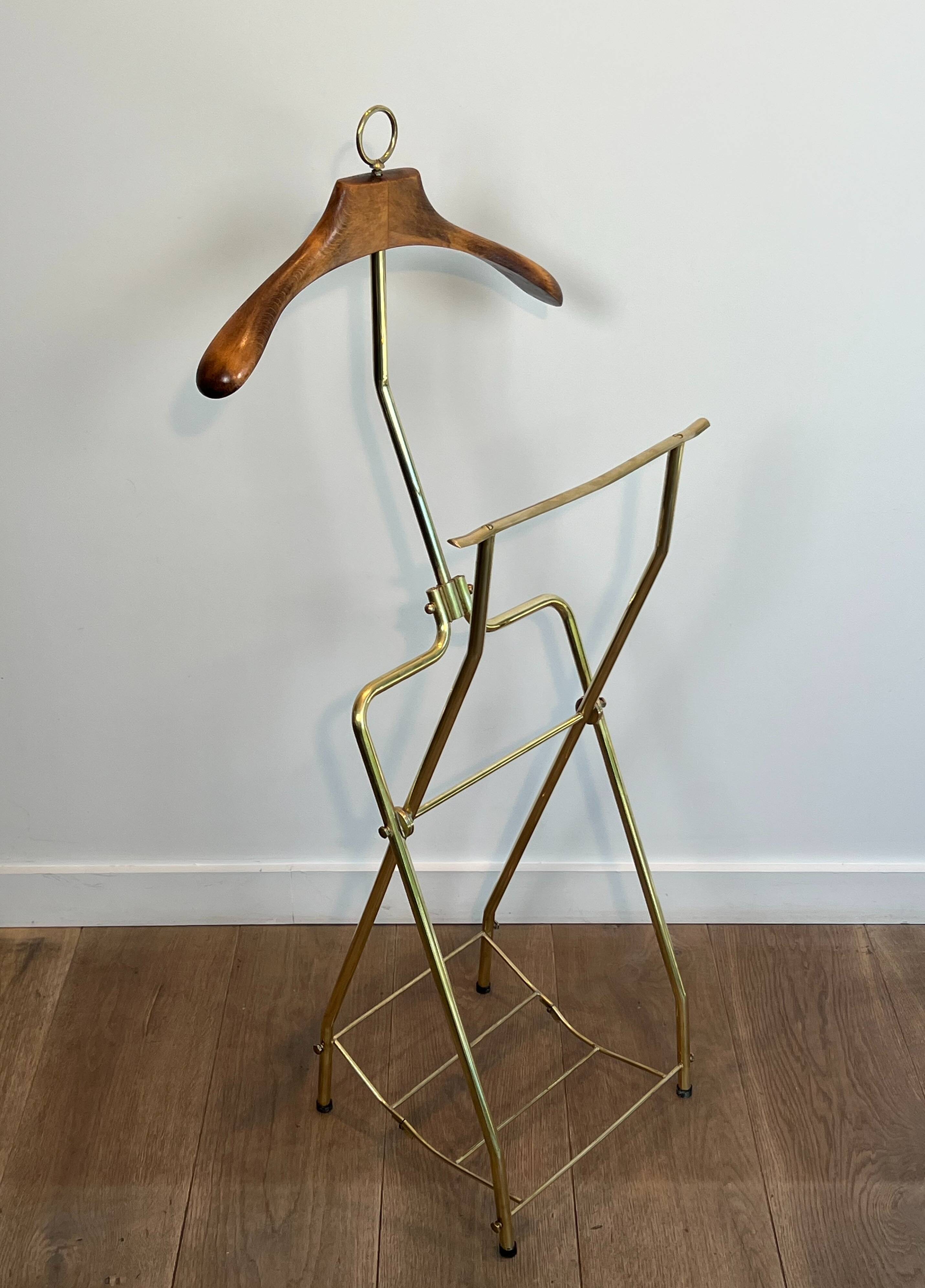 Neoclassical style valet stand in brass and black lacquered wood. French work. Circa 1940