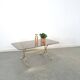 Smoked glass coffee table with gold-coloured legs from Sweden